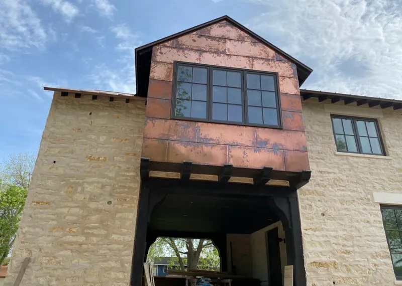 Copper metal panel facade on a stone building for Roof Repair in Fort Meade